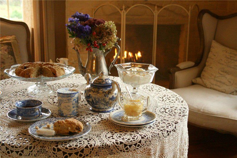 Warm tea ritual on a wooden table in a cozy Dutch evening setting